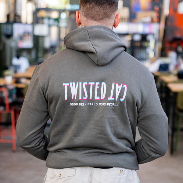 Person wearing a gray hoodie with 'Twisted Cat' branding in an indoor setting.