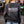 Person wearing a black sweatshirt with 'Twisted Cat' text, standing in an outdoor setting.